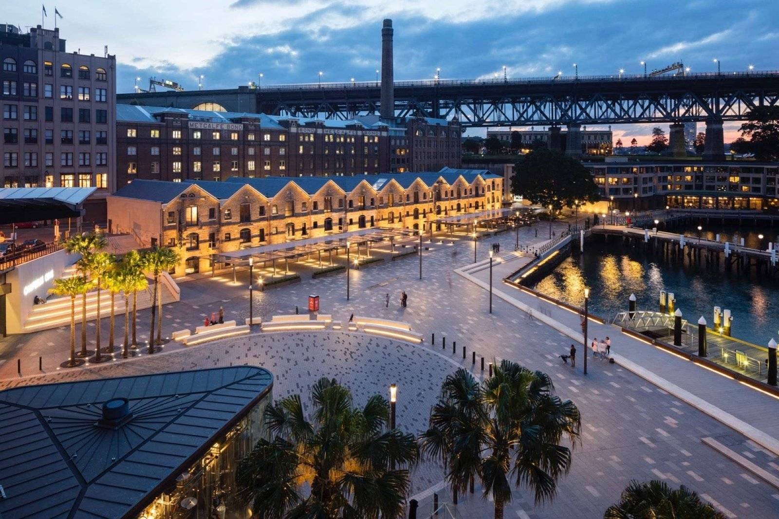 Waterfront plaza with historic buildings at dusk